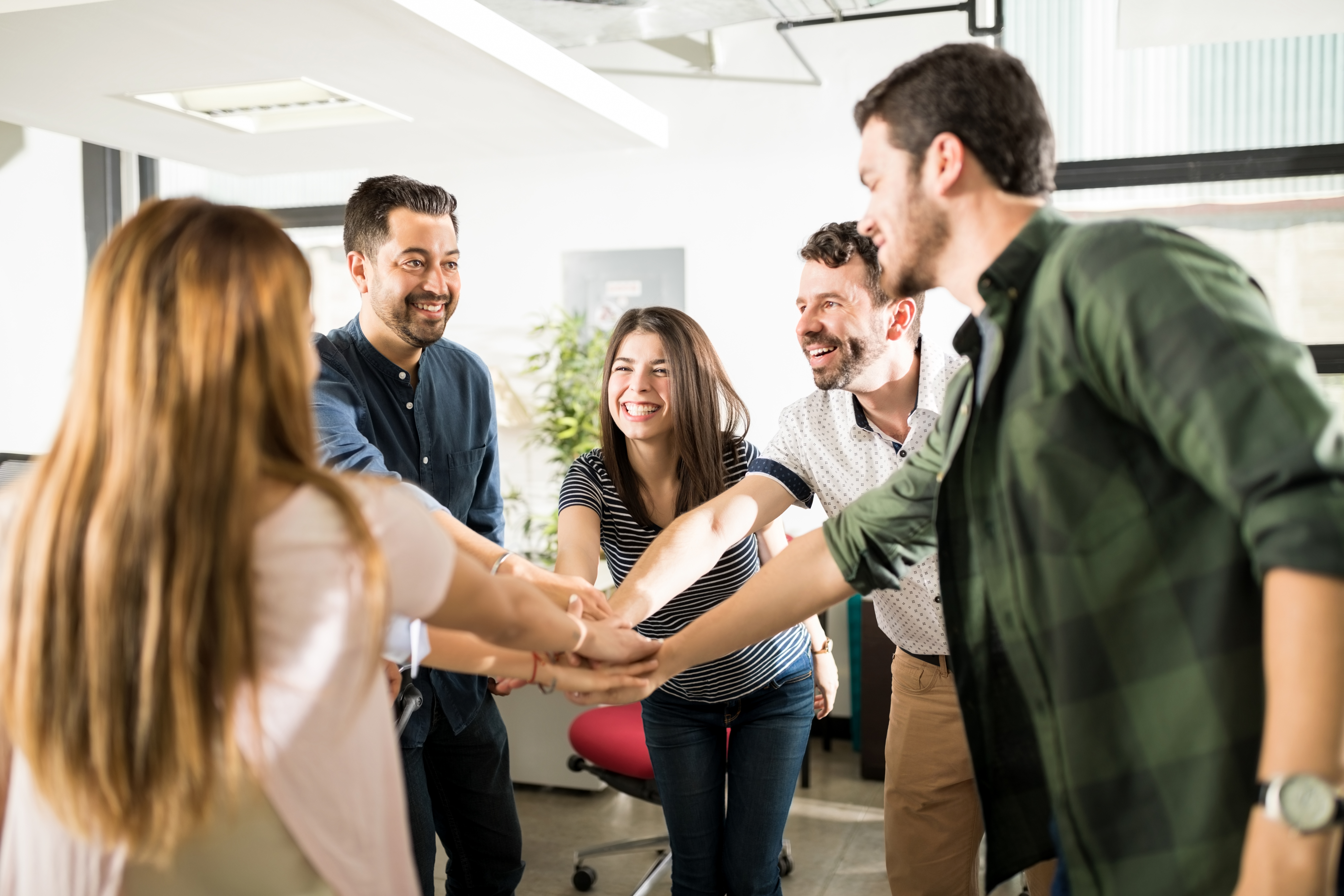 business-team-putting-their-hands-together-cooperation-success