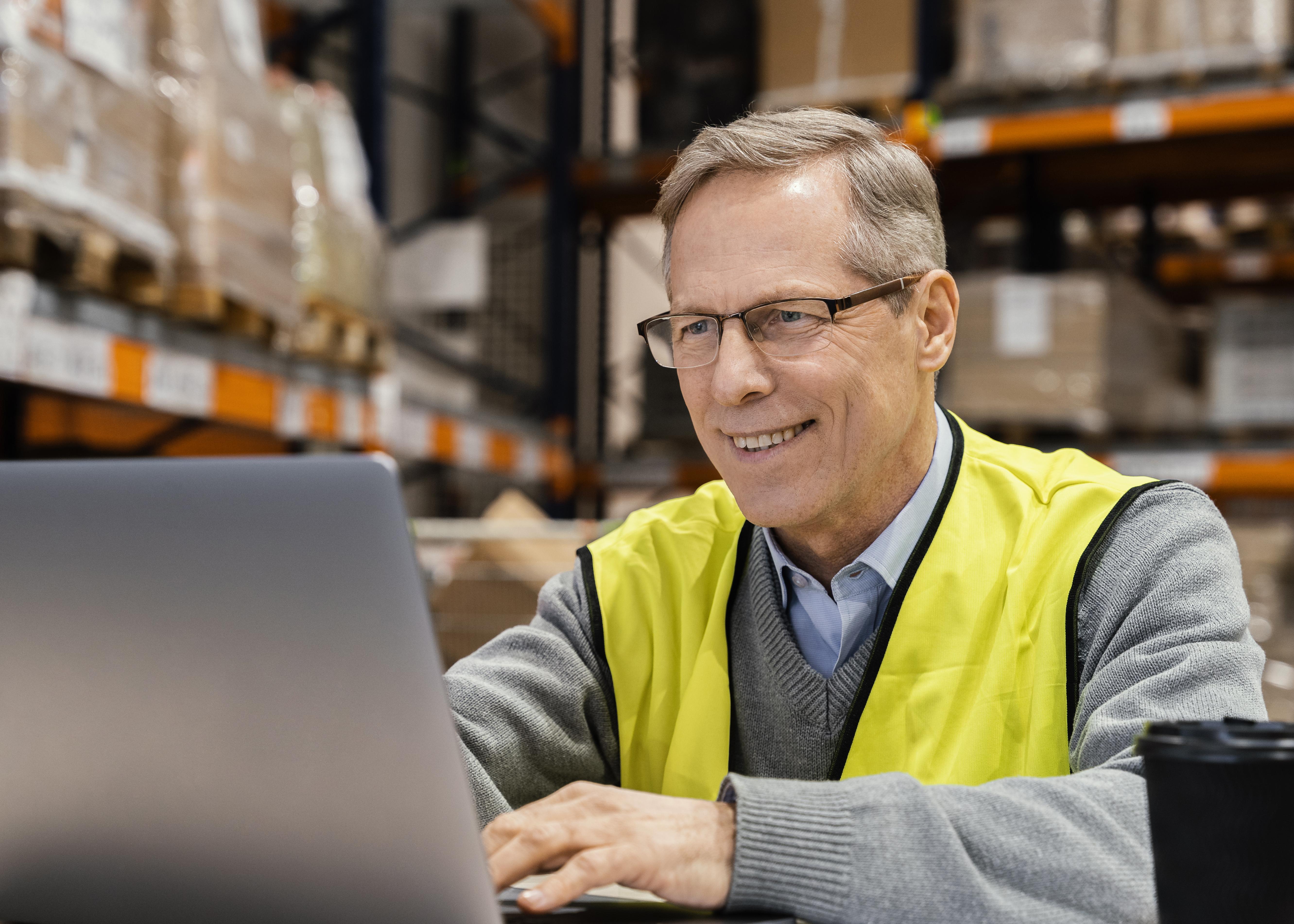 man-warehouse-working-laptop