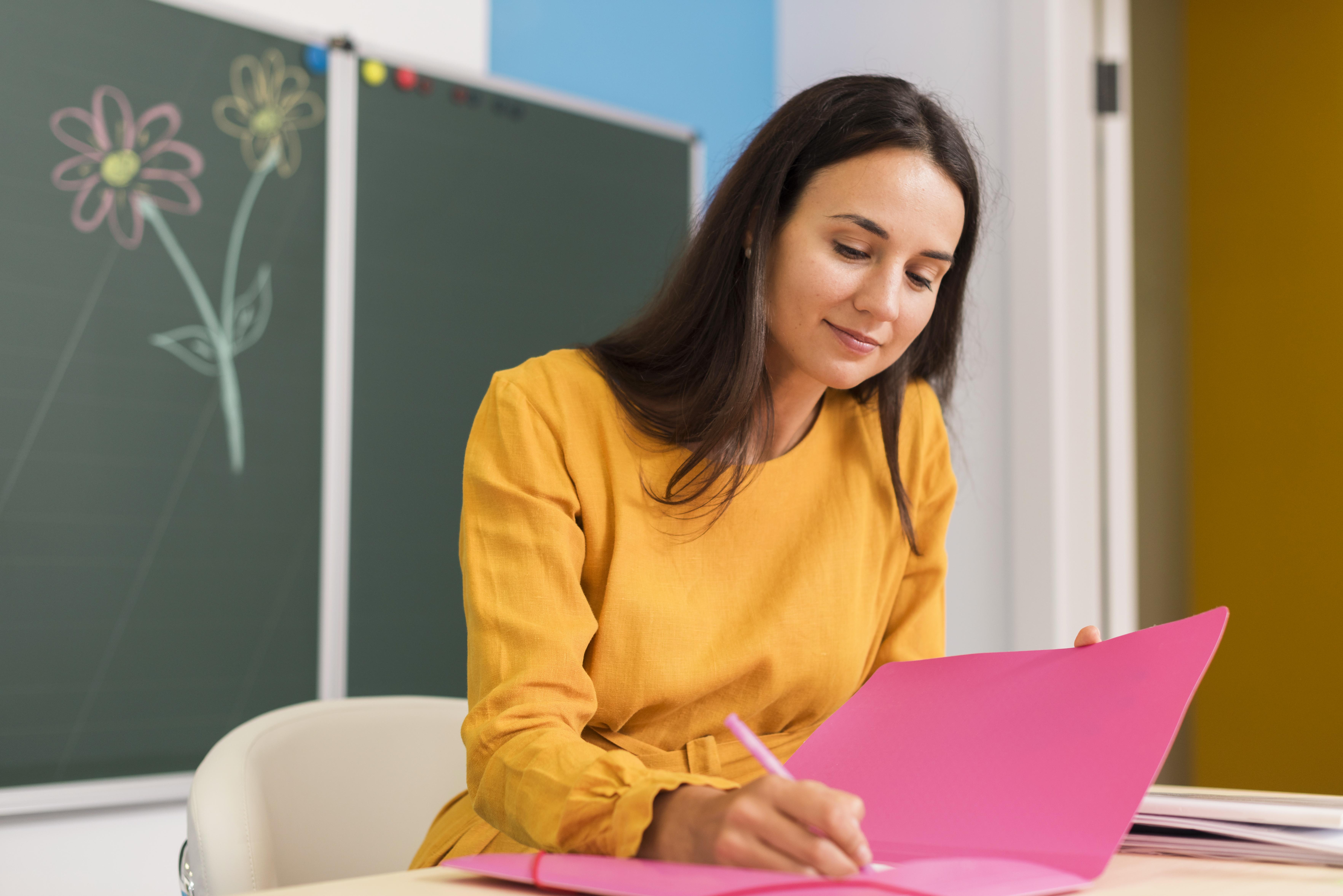 smiley-teacher-taking-notes