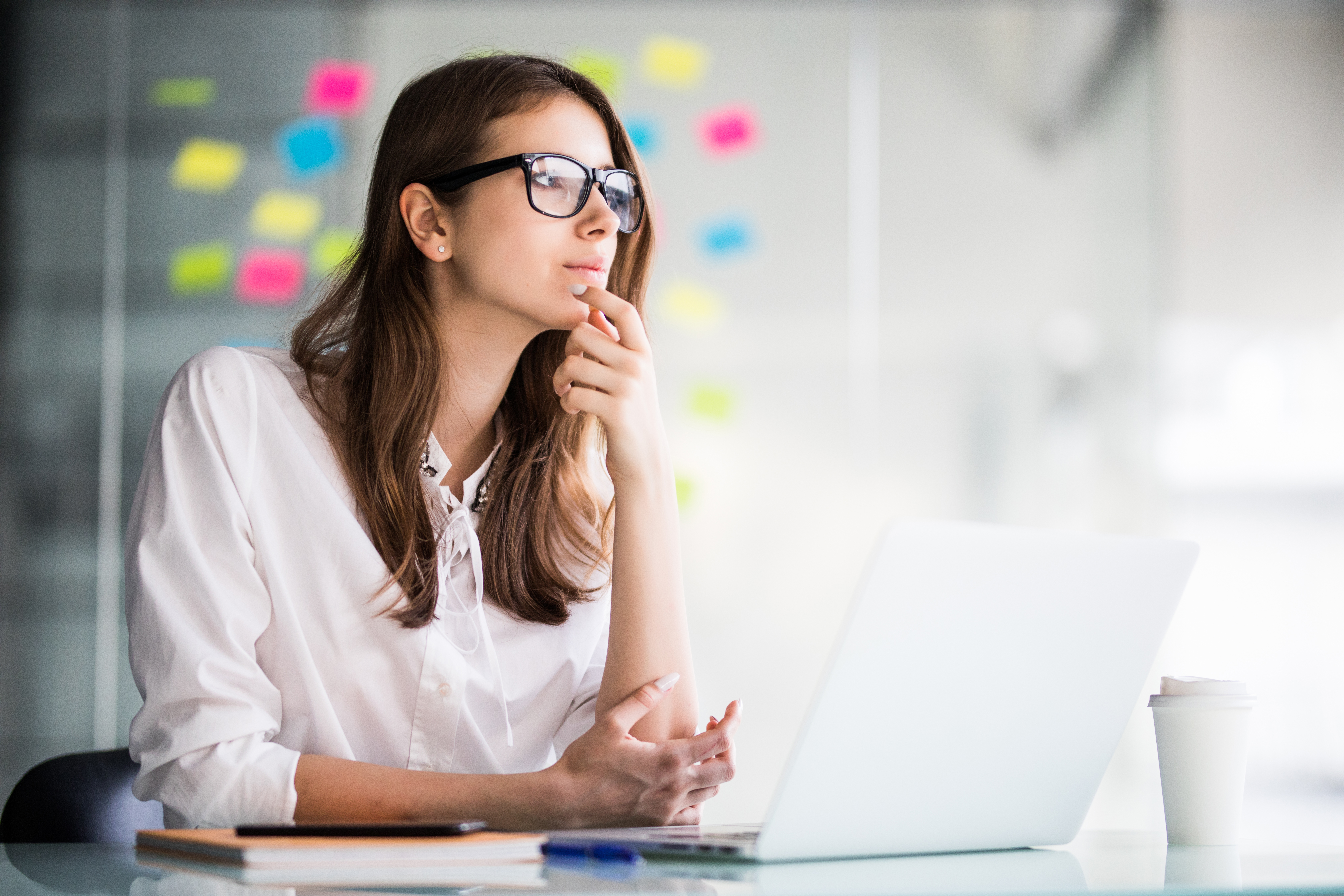 successful-businesswoman-working-laptop-computer-thinks-new-ideas-her-office-dressed-up-white-clothes