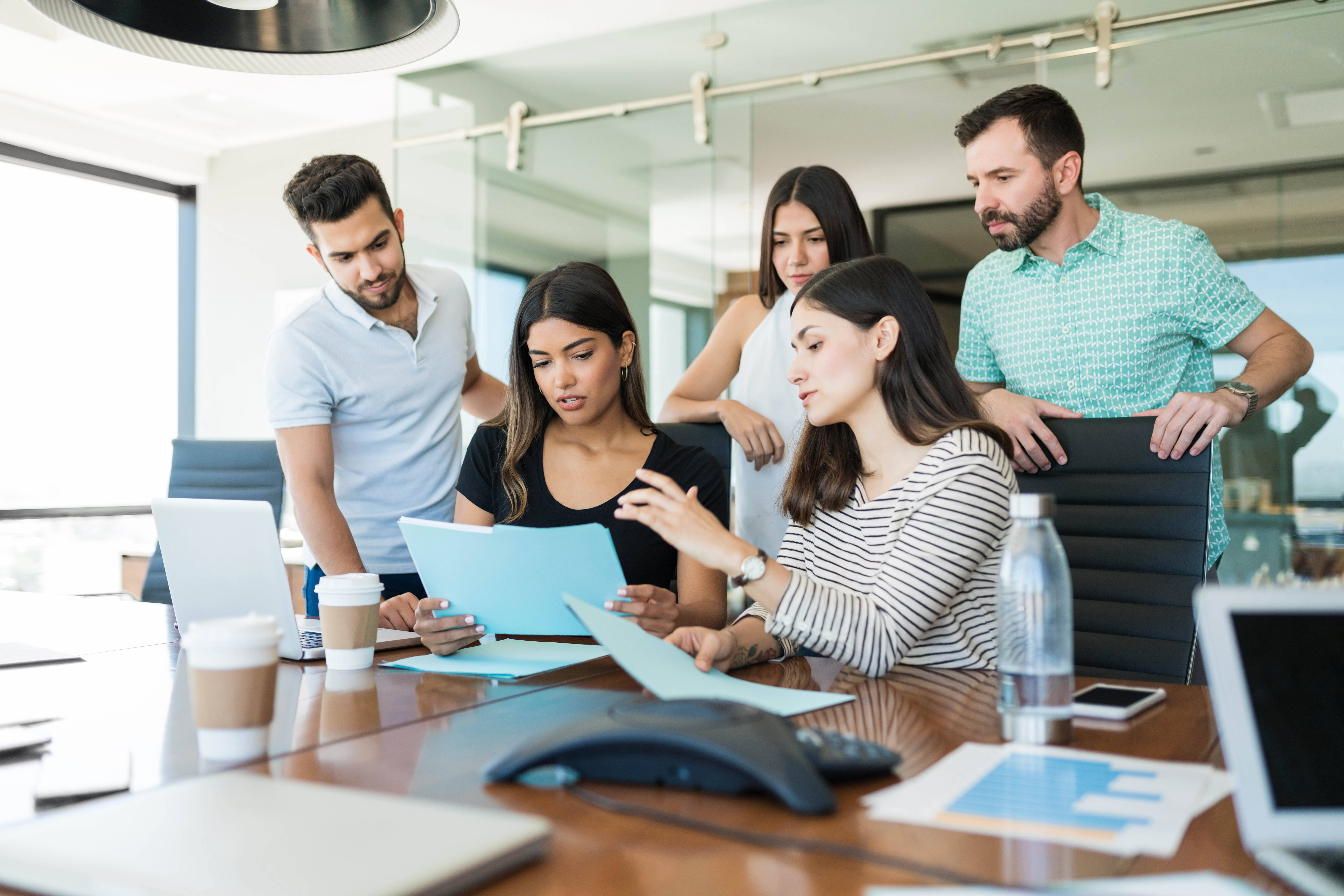 team-business-professionals-discussing-file-desk-creative-office-meeting