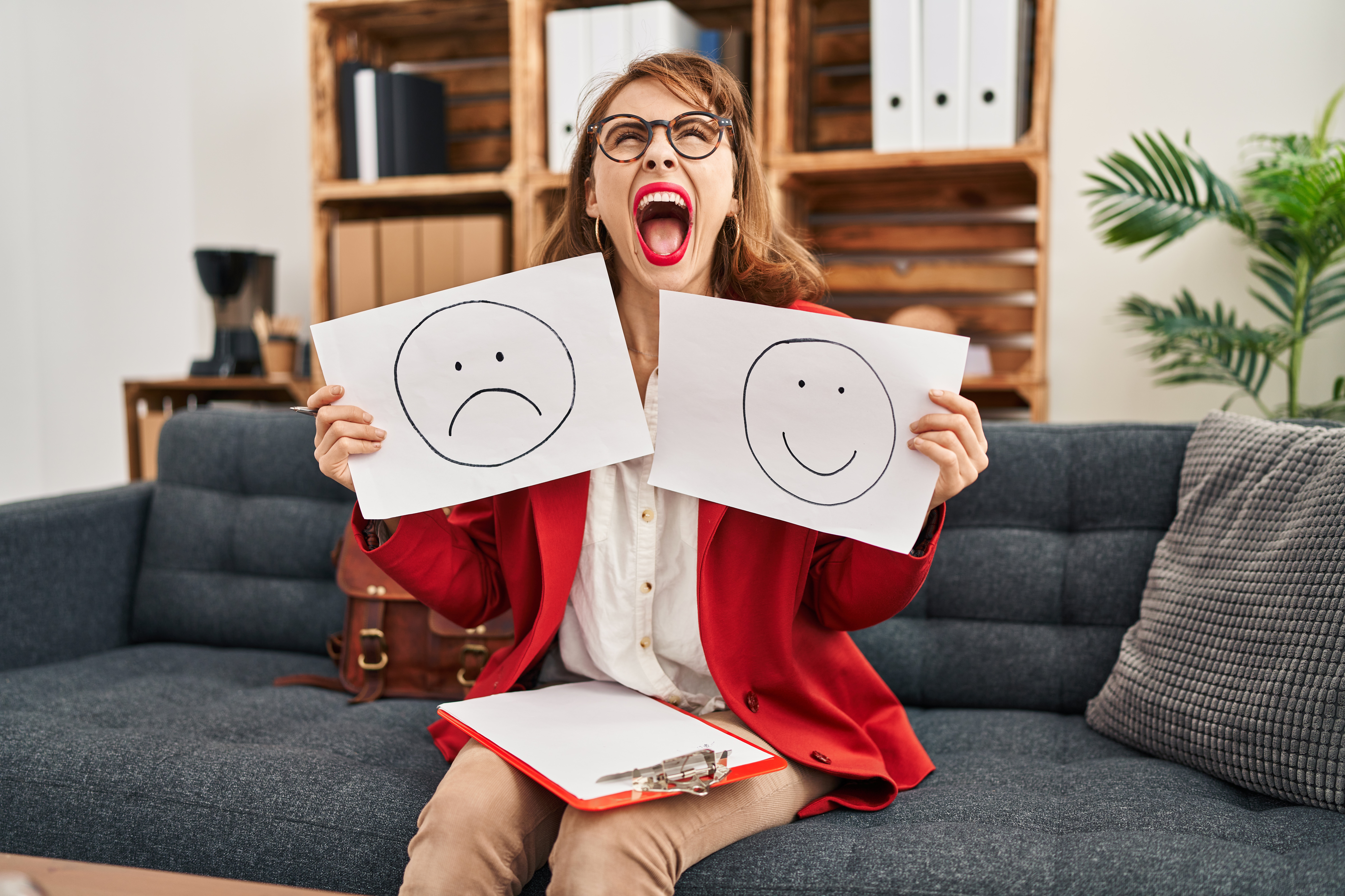 young-beautiful-woman-working-depression-holding-sad-happy-emotion-paper-angry-mad-screaming-frustrated-furious-shouting-with-anger-looking-up